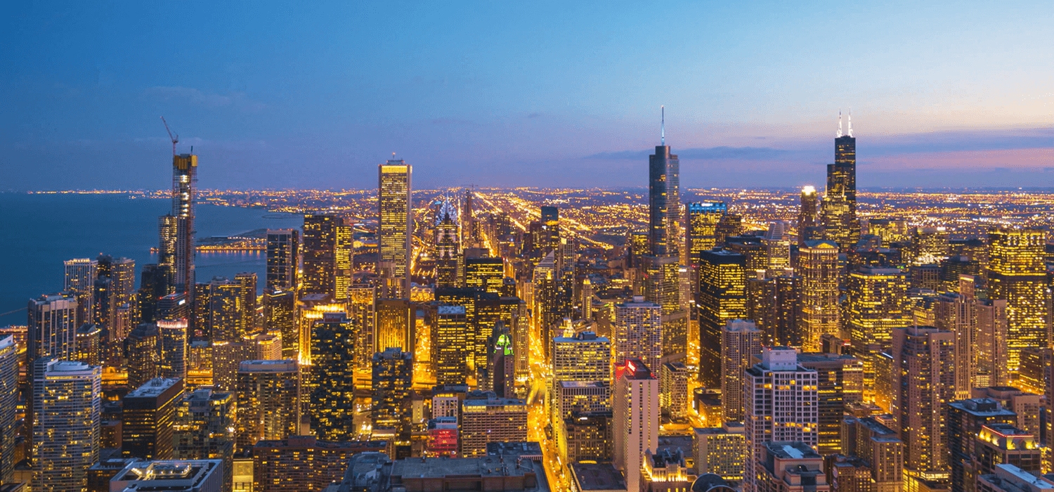 A vibrant city skyline at twilight with illuminated buildings.